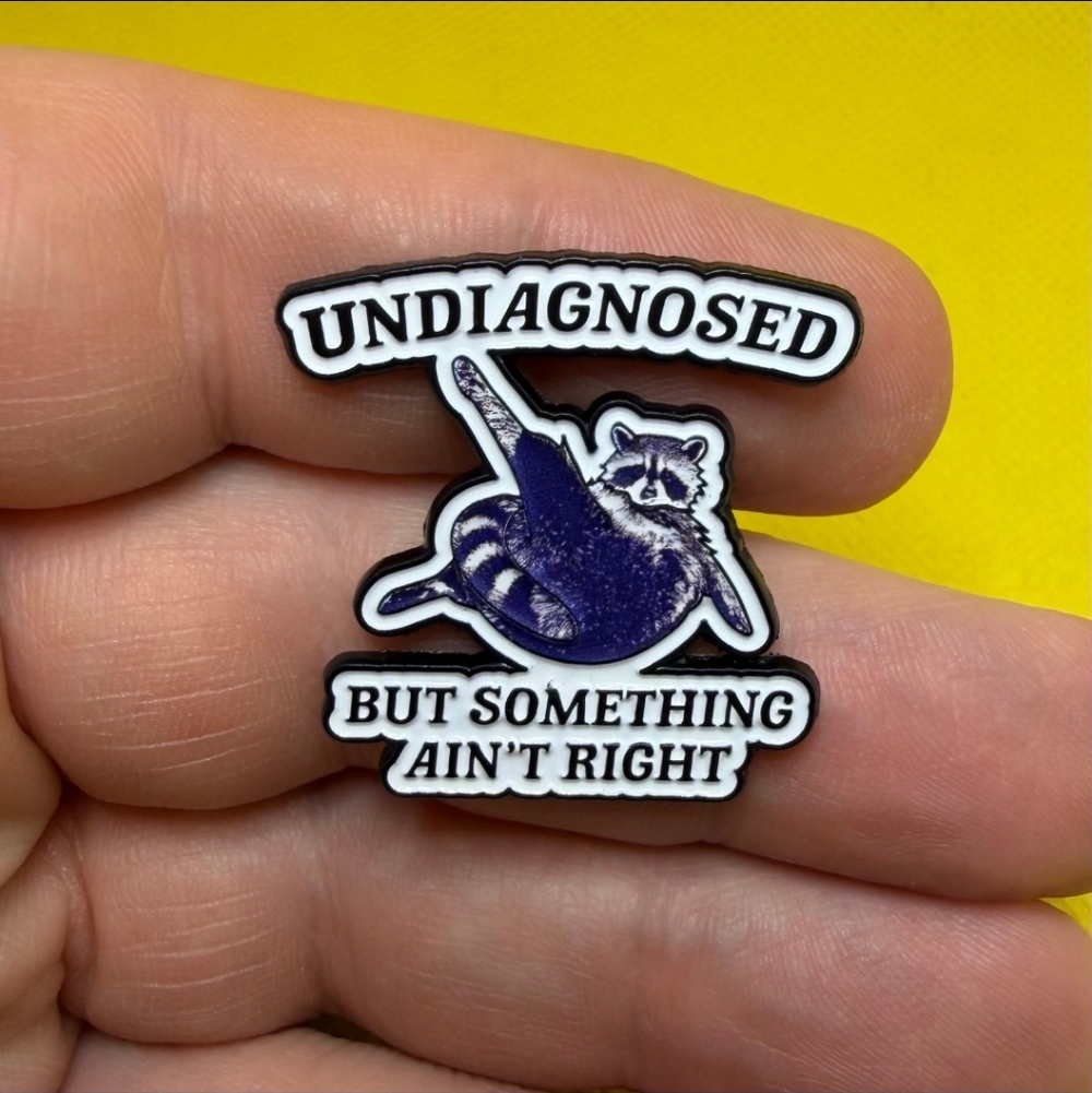 Undiagnosed Raccoon Enamel Pin — Purple & White